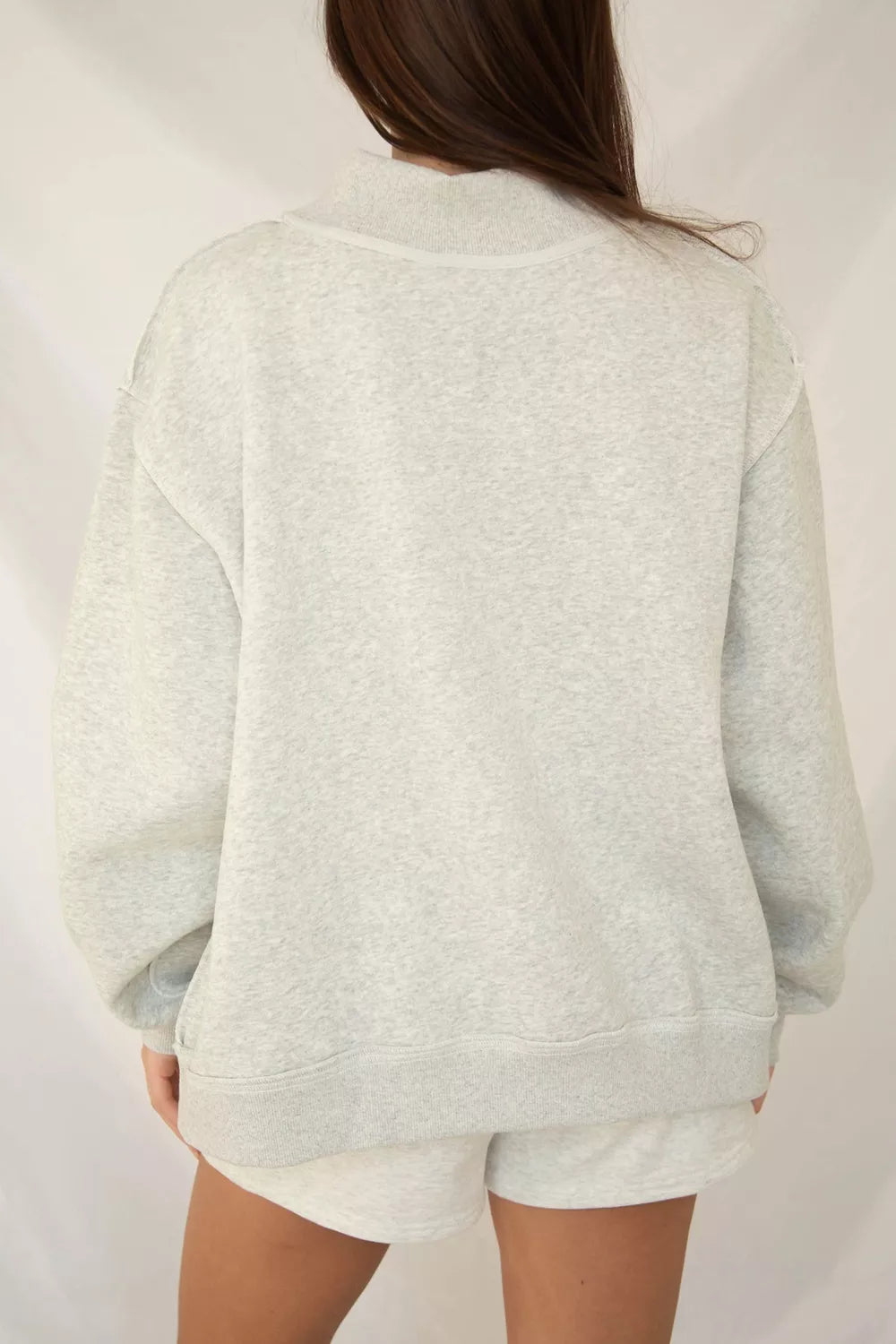 oversized cream sweatshirt with large pink striped JESUS lettering