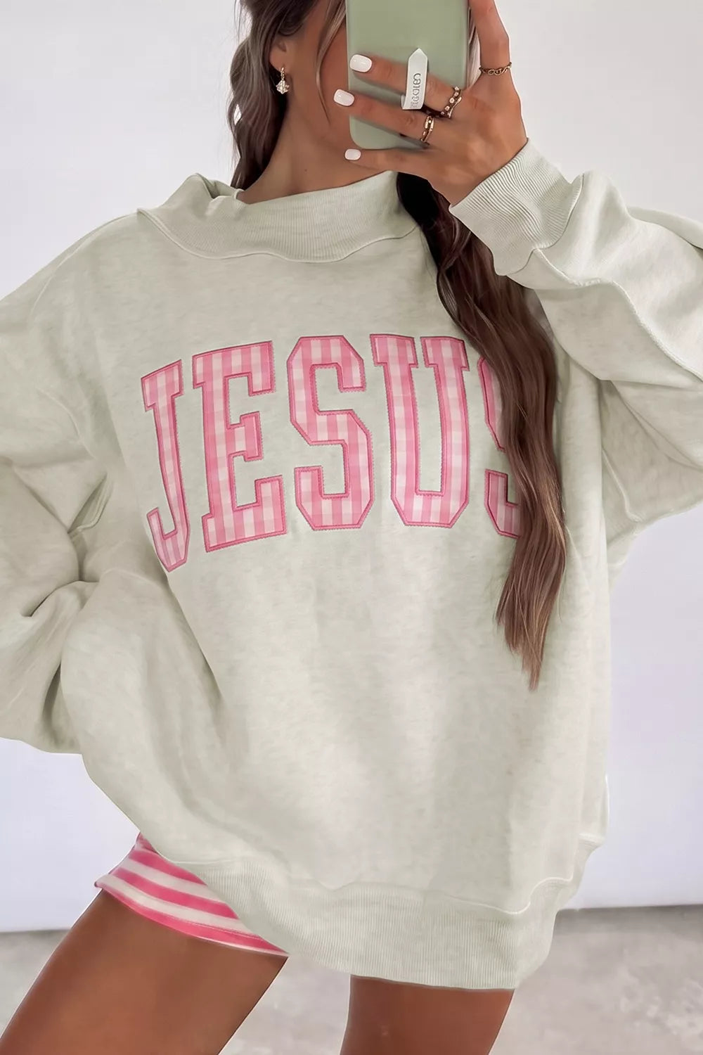  oversized cream sweatshirt with large pink striped JESUS lettering