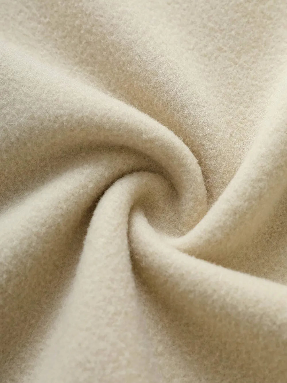 Close-up of beige fabric with a swirl pattern