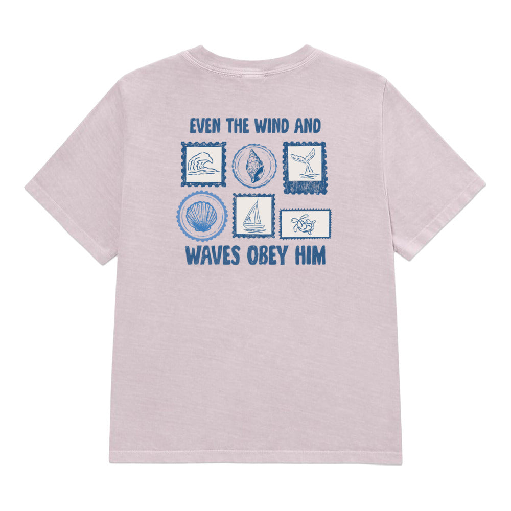 A light purple heathered t-shirt with a blue graphic print on the back. The print features the text 'EVEN THE WIND AND WAVES OBEY HIM' surrounding six nautical-themed postage stamp illustrations.