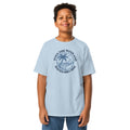 light blue Christian T-shirt with a navy palm tree, surfboard, and ocean graphic surrounded by “Even the wind and waves obey Him“