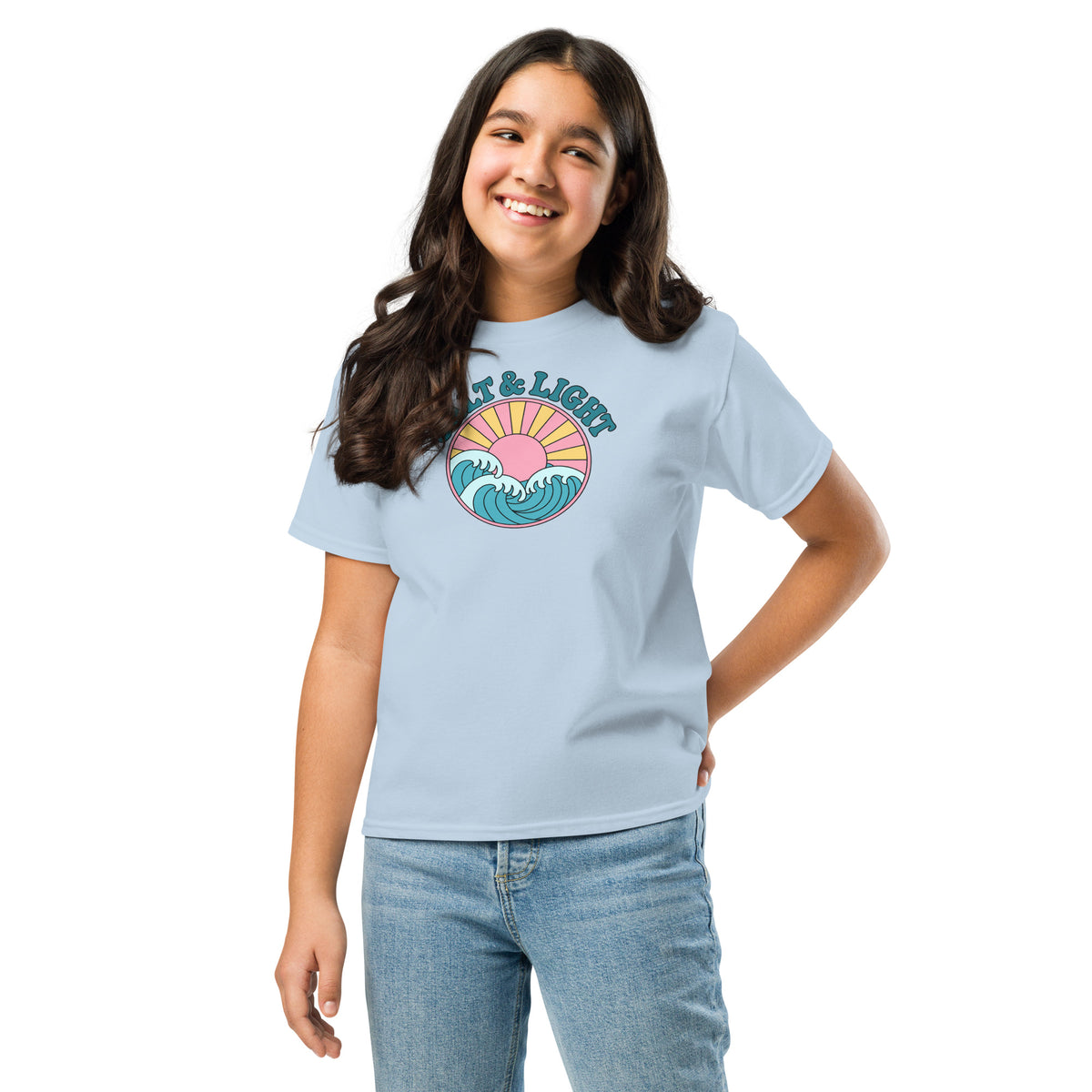 Girl wearing a light blue “Salt & Light” Christian T-shirt with teal lettering, ocean waves, and a yellow sunburst