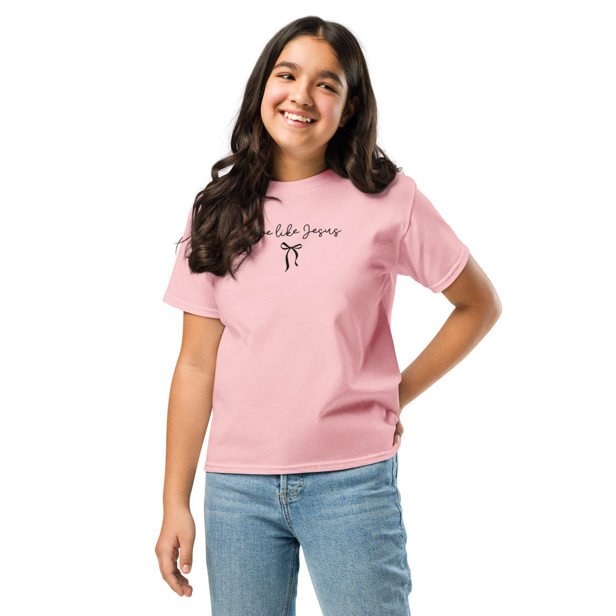 Youth light pink Christian T-shirt with ‘Love Like Jesus’ script and black bow design