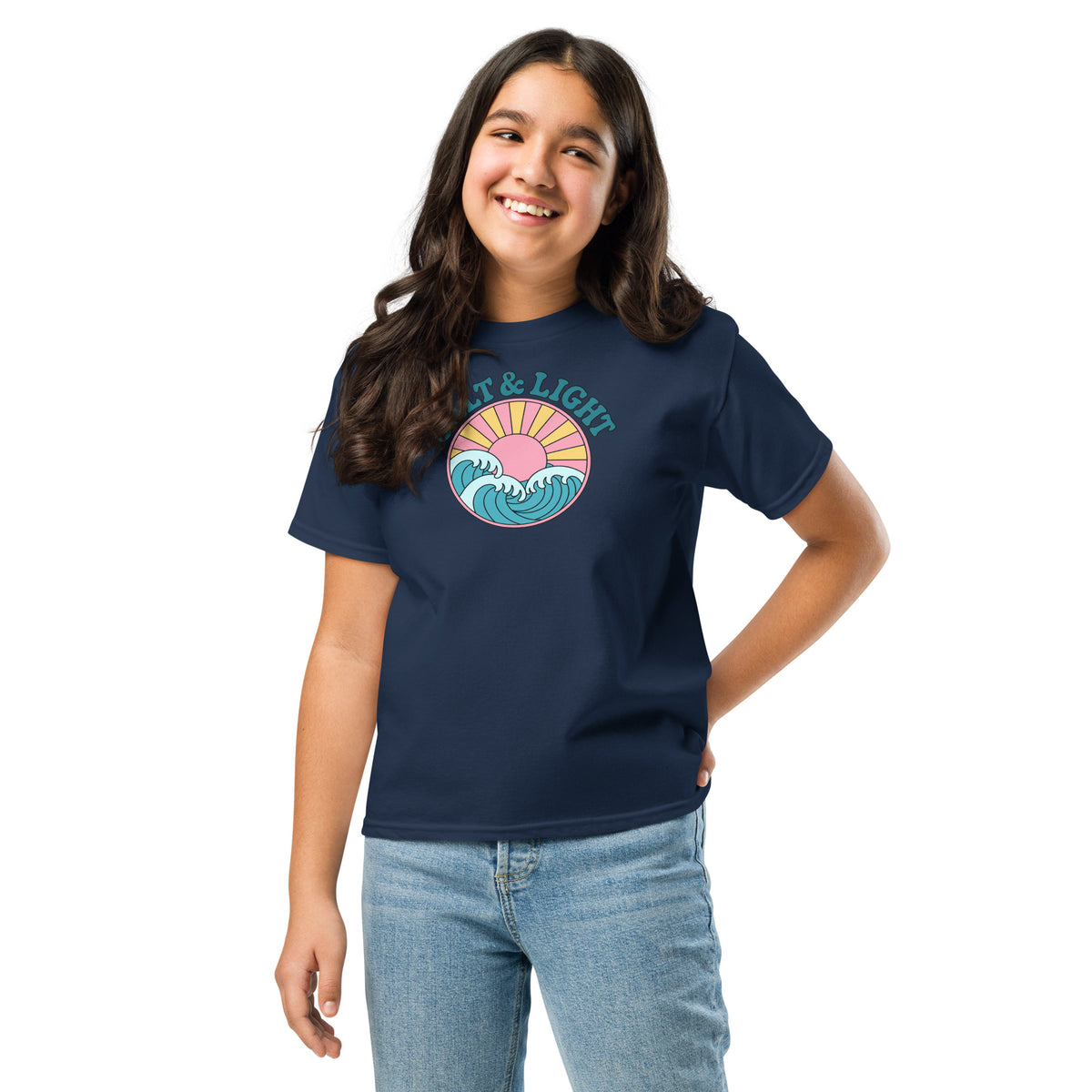 Girl wearing a navy blue “Salt & Light” Christian T-shirt with teal lettering, ocean waves, and a yellow sunburst